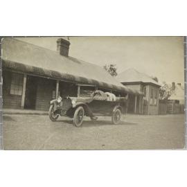 Motorcar outside country hotel