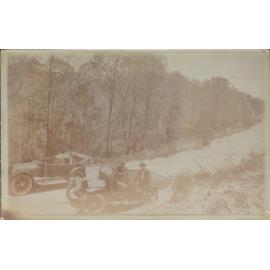 Car and utility stopped on mountain road