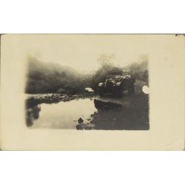 Car stopped at flooded creek crossing