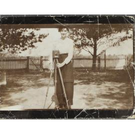 Girl with box camera on a tripod