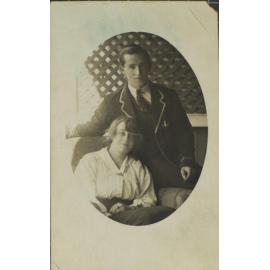 Boy in blazer and girl seated in loungechair
