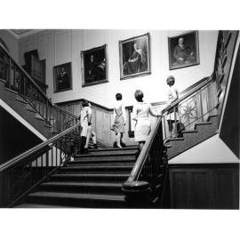 Armidale Teachers' College students admiring portraits in the College foyer, c.1965