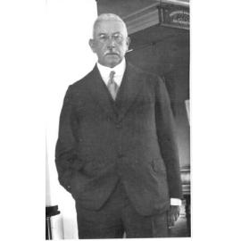 Howard Hinton standing beside a sign saying Howard Hinton Benefactor