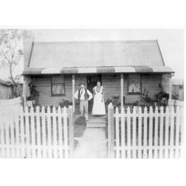 Mr and Mrs A. McWatters outside their 4-roomed miner's cottage, Hillgrove, NSW