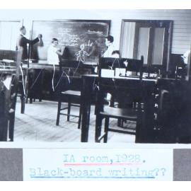 Students and a teacher at the blackboard in room 1A, 1928