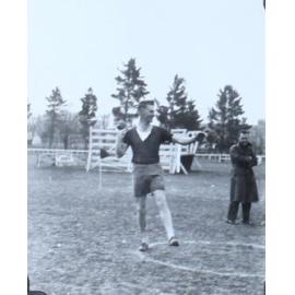 Male student commencing a shot putt throw
