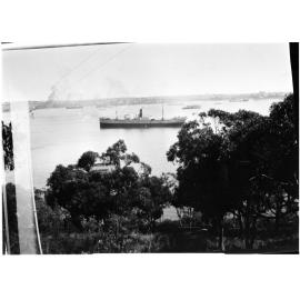 Unidentified stretch of harbour with a steam ship in the centre