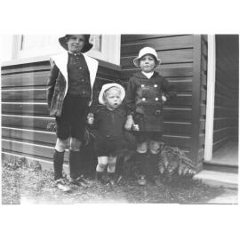 Three unidentified children standing in the front garden of 63 Barney Street, Armidale