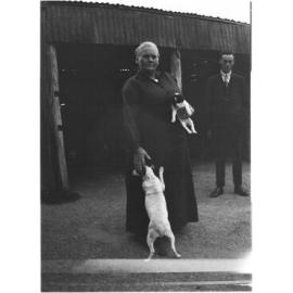 Unidentified woman with two dogs