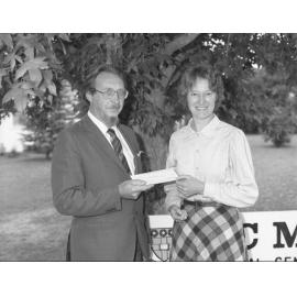 Professor J. Nalson presenting a cheque to Dr Cunningham for M.J. Lewis (MS sufferer), 1996